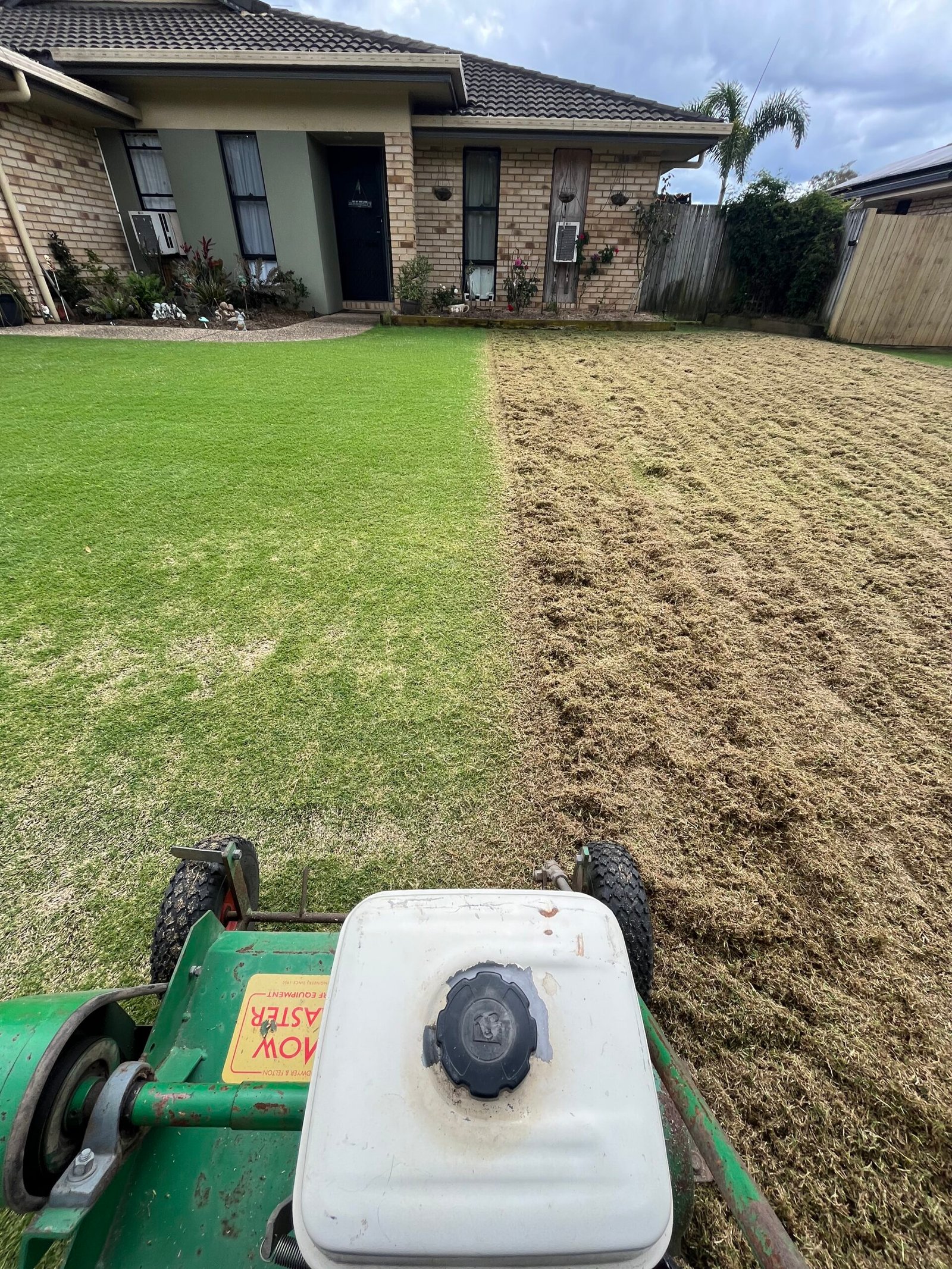 The Lawn Technician dethatching a tired residential lawn